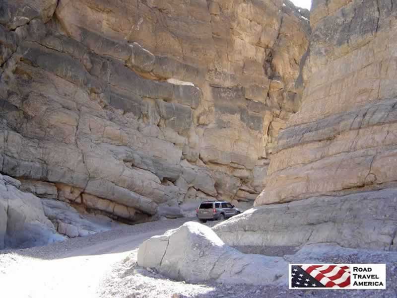 The narrow passage between towering rocks in Titus Canyon Road in Death Valley National Park