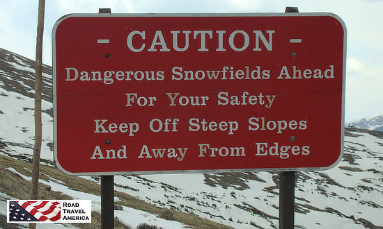 Near the peak of Trail Ridge Road in Rocky Mountain National Park ... CAUTION: Dangerous snowfields ahead; for your safety keep off steep slopes and away from edges