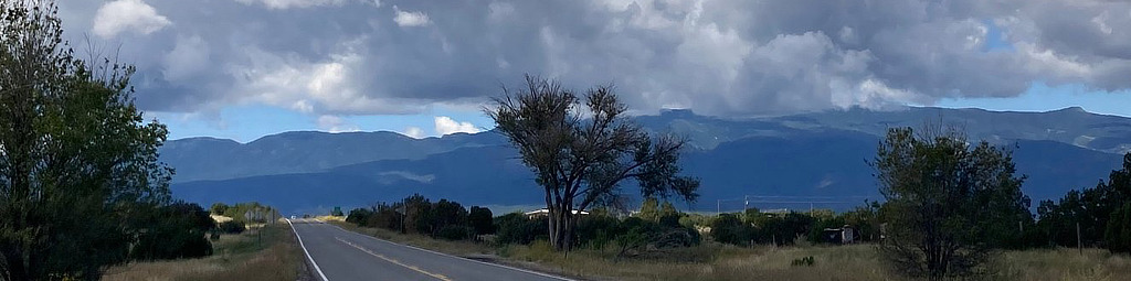 Scene along the Turquoise Trail with snow-capped mountains in the distance