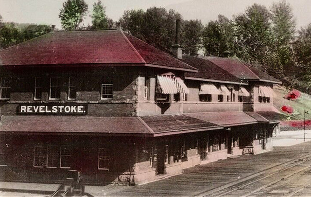 Vintage postcard of the Canadian Pacific Railway (CPR) station with its classic, handpainted "REVELSTOKE." sign. Period.