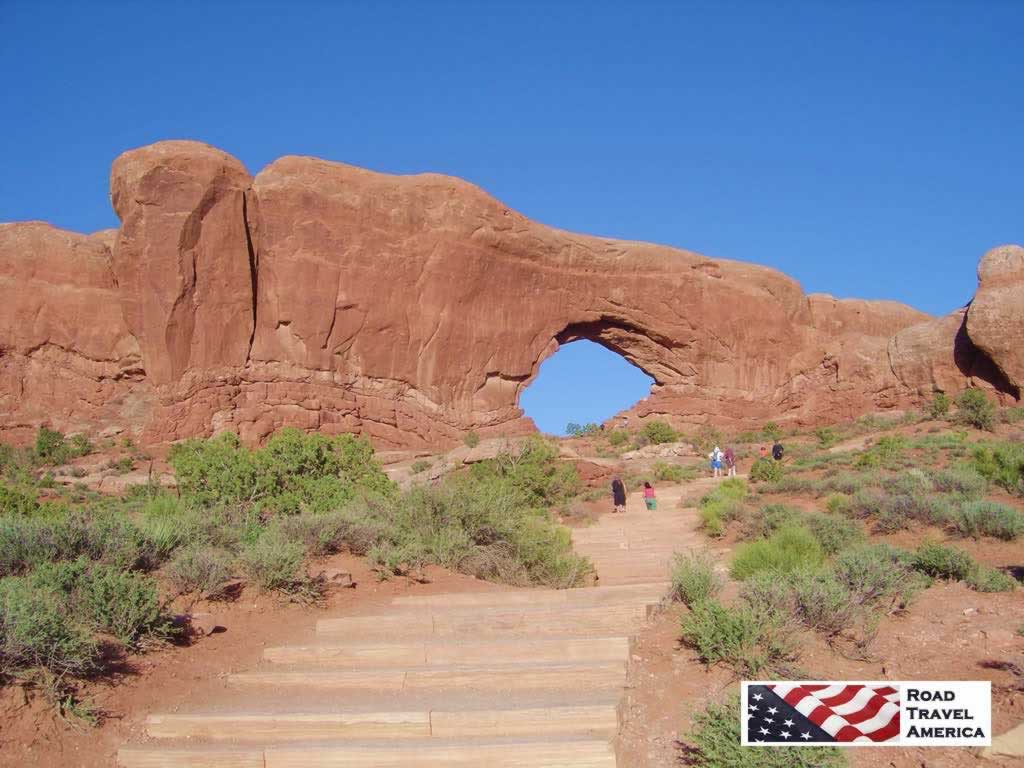 Visitors climbing stone steps to get a closer view of one of the huge single arches at the park