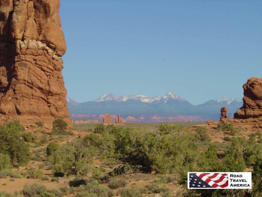 Snow-capped mountains in the distance at Arches National Park