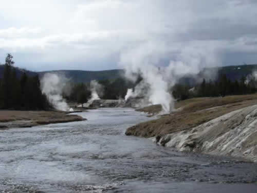 Geysers and steam vents along the river near Old Faithful at Yellowstone National Park